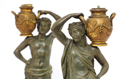 Lot 203 - A pair of bronze figural candlesticks