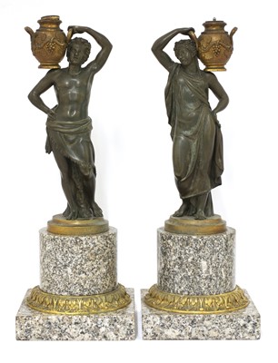 Lot 203 - A pair of bronze figural candlesticks