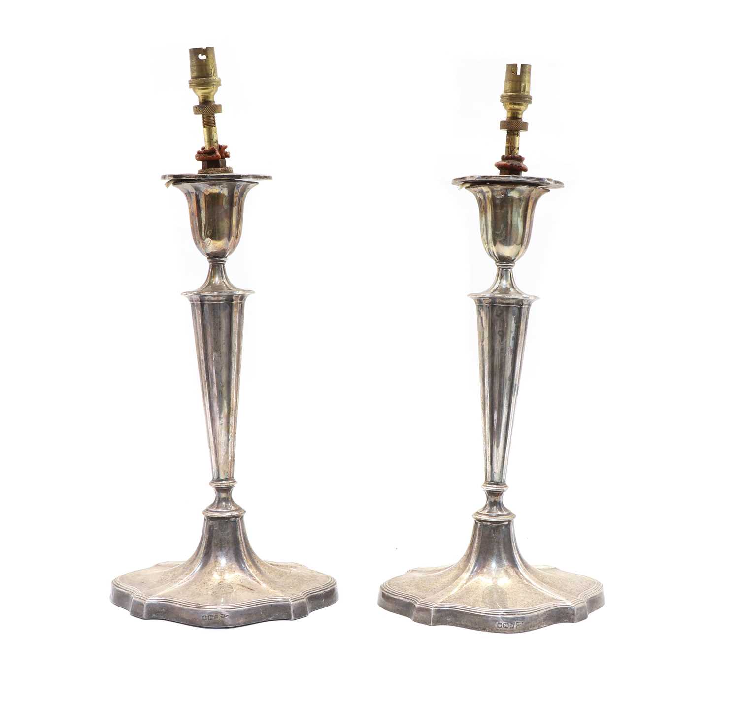 Lot 12 - A pair of early 20th century silver candlesticks