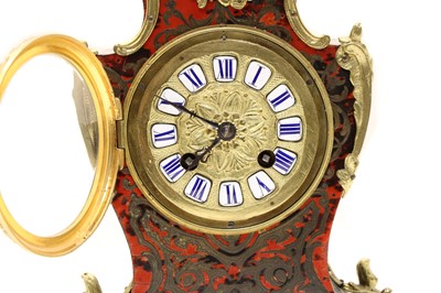 Lot 185 - A French red boulle and ebonised mantel clock