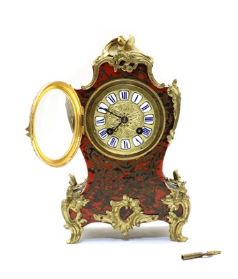 Lot 185 - A French red boulle and ebonised mantel clock