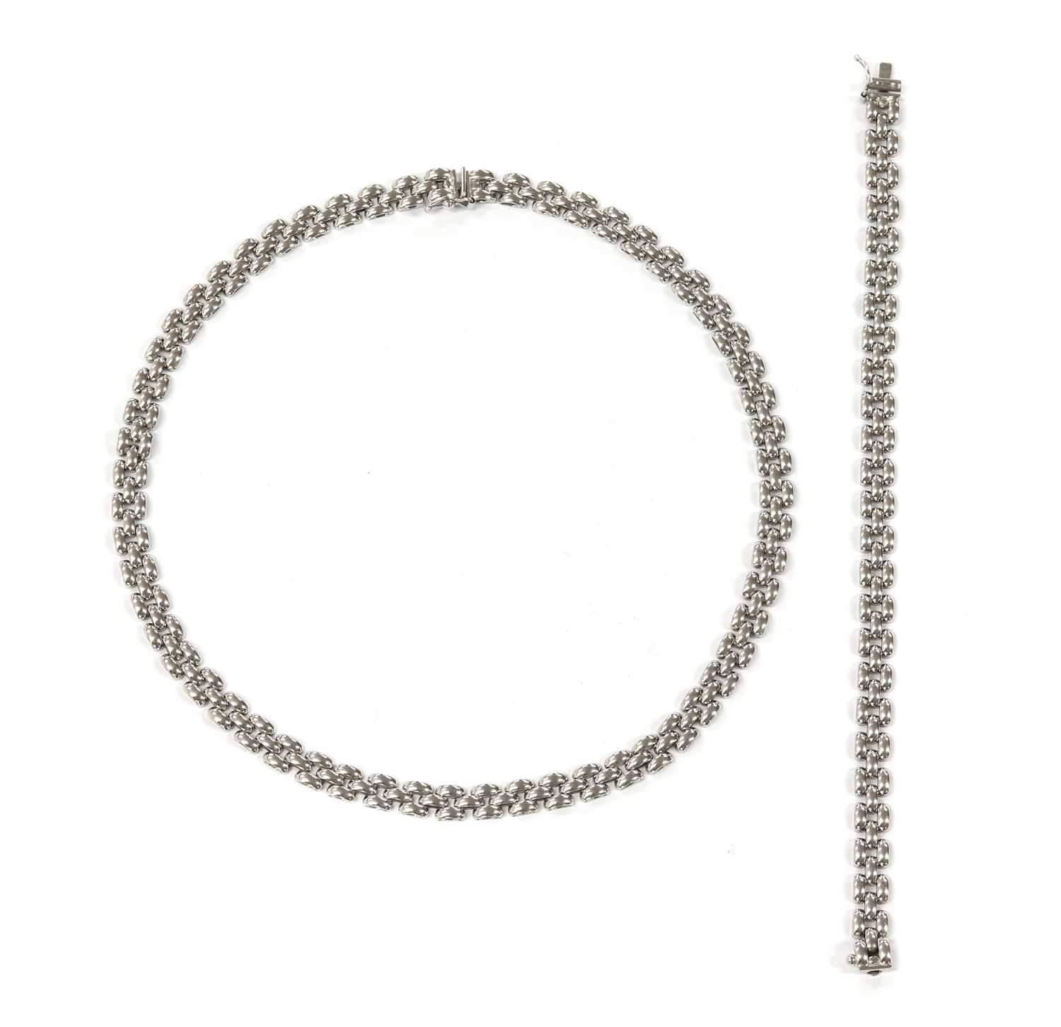 Lot 1123 - A 9ct white gold panther link necklace and bracelet suite