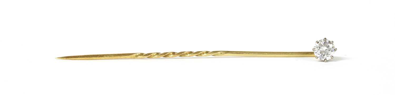 Lot 1173 - A gold single stone diamond stick pin