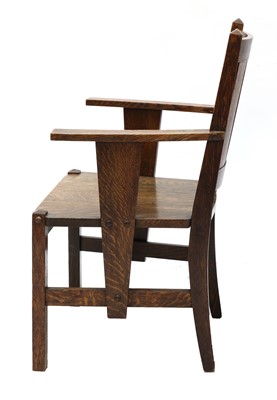 Lot 87 - An Arts and Crafts oak elbow chair