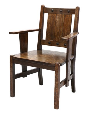 Lot 87 - An Arts and Crafts oak elbow chair