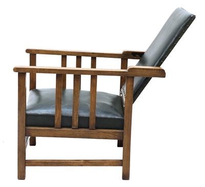 Lot 86 - An Arts and Crafts oak reclining armchair