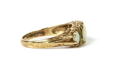 Lot 1262 - A 9ct gold opal and peridot ring