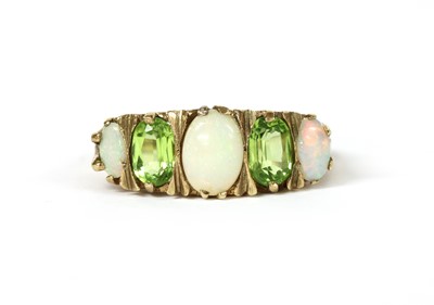 Lot 1262 - A 9ct gold opal and peridot ring