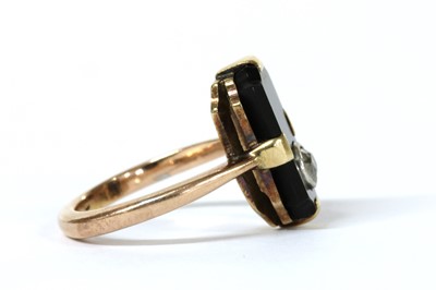 Lot 1045 - A gold diamond and onyx ring