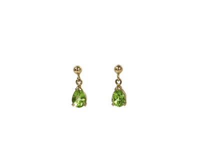 Lot 1259 - A pair of gold peridot drop earrings