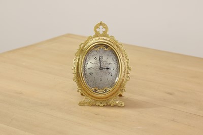 Lot 228 - An oval brass strut clock