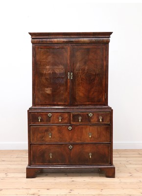 Lot 307 - A walnut and feather-banded cabinet on chest
