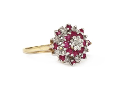 Lot 1221 - A 9ct gold diamond and ruby target cluster ring