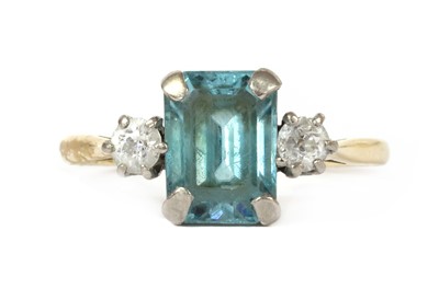 Lot 1293 - A gold blue zircon and diamond three stone ring