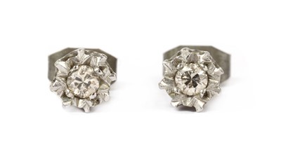 Lot 1210 - A pair of 9ct white gold single stone diamond stud earrings