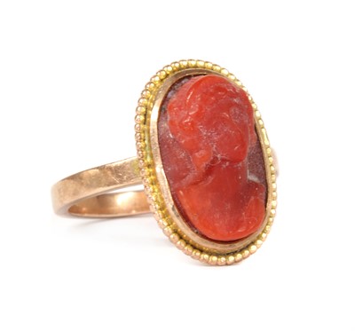 Lot 1238 - A gold coral cameo ring