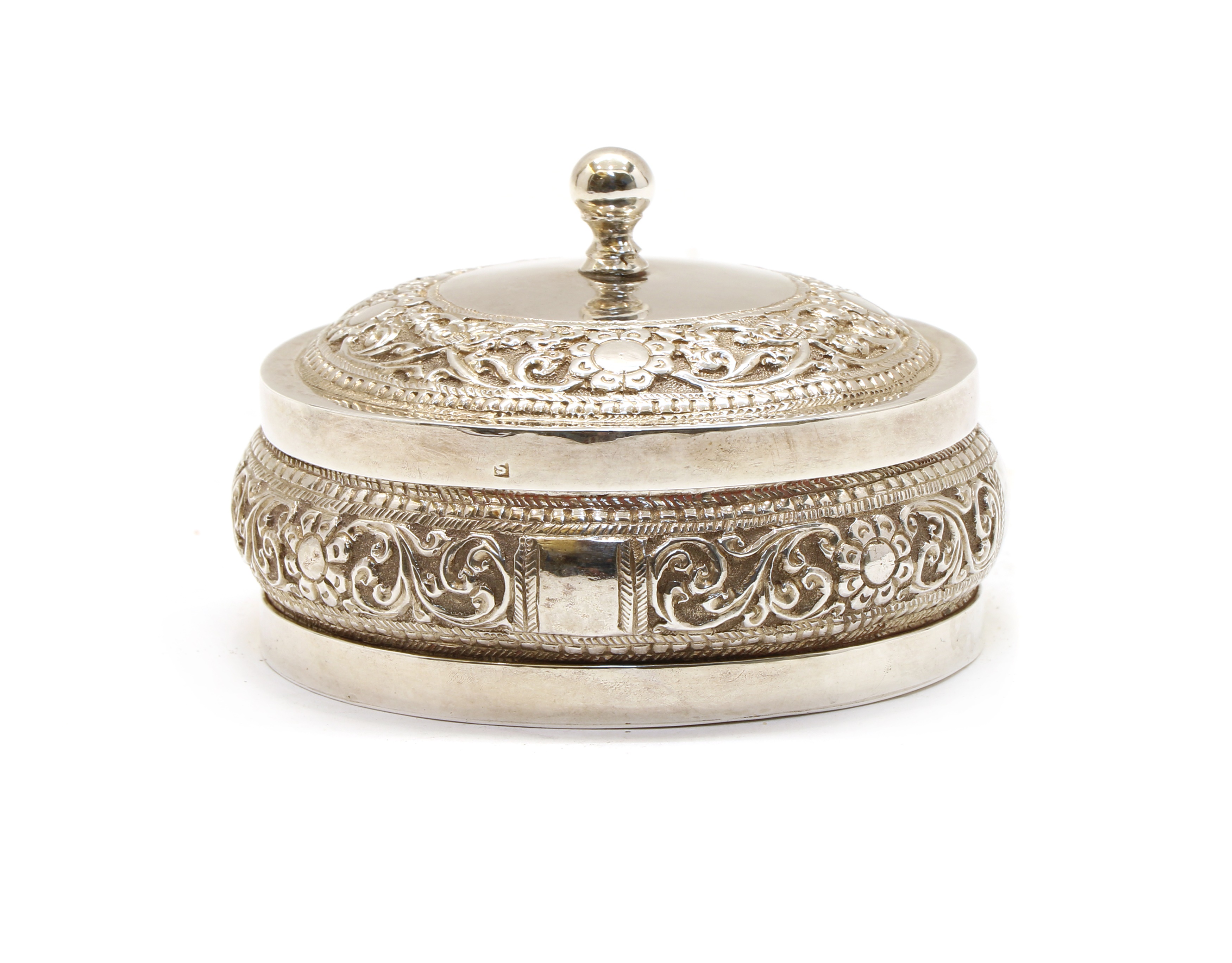 Lot 17 - An Indian white metal jar and cover of squat