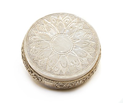 Lot 17 - An Indian white metal jar and cover of squat circular form