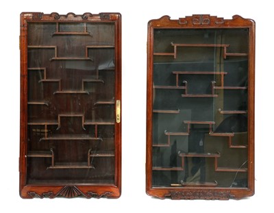 Lot 117A - A near pair of Chinese carved hardwood hanging display cabinets