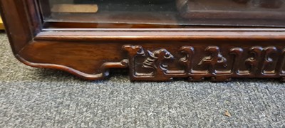 Lot 117 - A near pair of Chinese carved hardwood hanging display cabinets