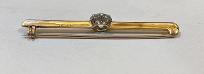 Lot 1165 - A gold and platinum single stone diamond bar brooch