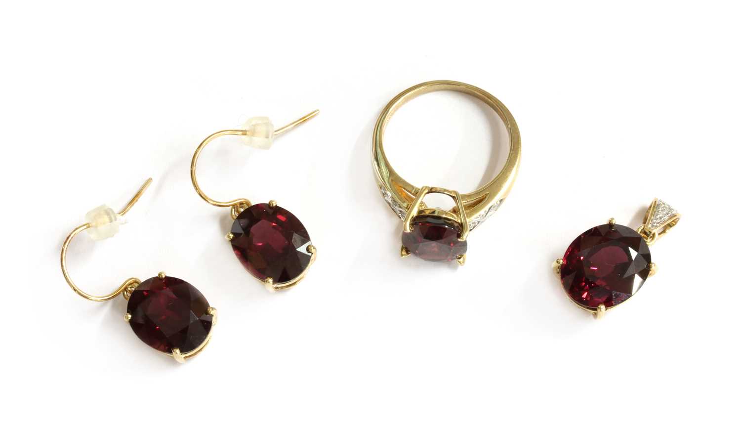 Lot 98 - A 9ct gold garnet and diamond ring, pendant and earrings suite