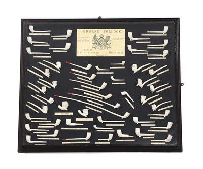 Lot 157A - A glazed case display of clay pipes