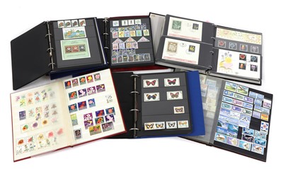 Lot 258 - A large quantity of stamps and postcards in approximately forty albums