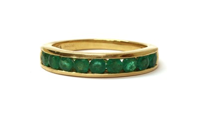 Lot 158 - An 18ct gold emerald half eternity ring