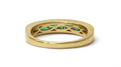 Lot 158 - An 18ct gold emerald half eternity ring