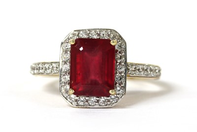 Lot 94 - A 9ct gold fracture filled ruby and zircon halo cluster ring
