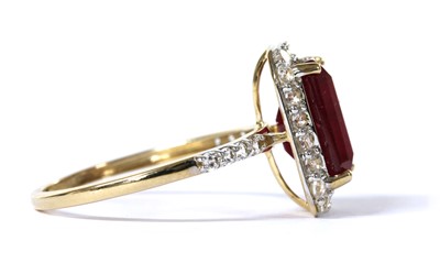 Lot 233 - A 9ct gold fracture filled ruby and zircon halo cluster ring