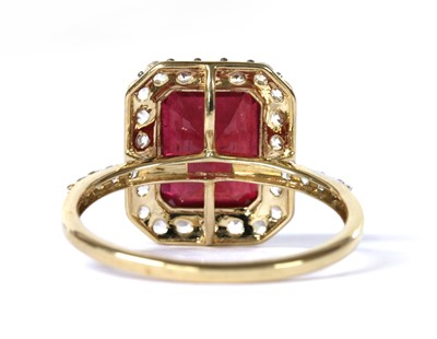 Lot 233 - A 9ct gold fracture filled ruby and zircon halo cluster ring