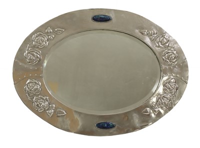 Lot 344 - An Arts and Crafts silver-plated oval wall mirror