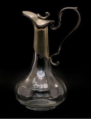 Lot 265 - An Art Nouveau pewter mounted glass claret jug