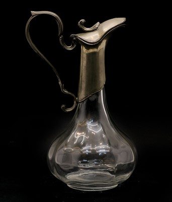 Lot 265 - An Art Nouveau pewter mounted glass claret jug
