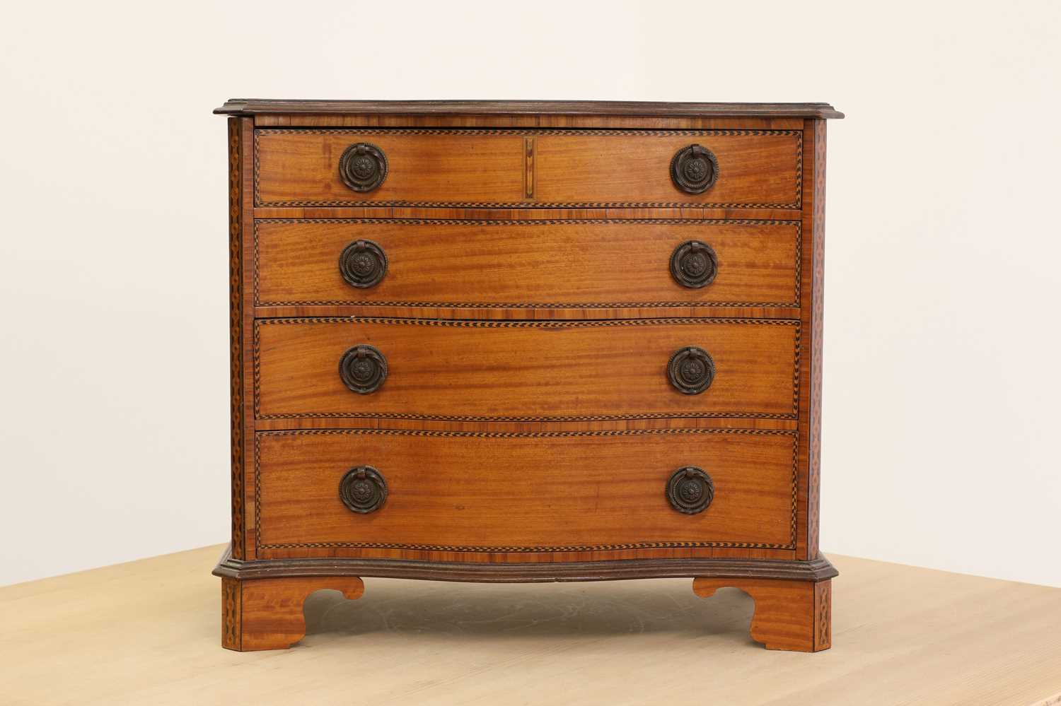 Lot 240 - A George III-style inlaid satinwood miniature chest of drawers