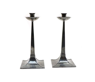 Lot 78 - A pair of Arts and Crafts-style silver candlesticks