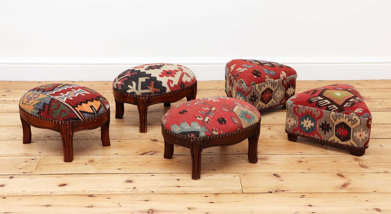 Lot 266 A collection of kilimupholstered footstools