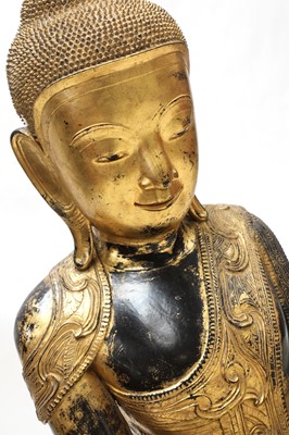 Lot 386 - A large Burmese gilt-lacquered papier-mâché Shakyamuni Buddha