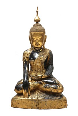 Lot 386 - A large Burmese gilt-lacquered papier-mâché Shakyamuni Buddha
