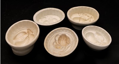 Lot 261 - A collection of seven glass and eight white pottery jelly moulds