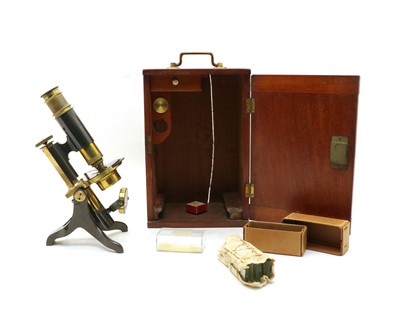 Lot 339 - A late 19th century brass/iron monocular microscope