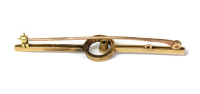Lot 11 - A gold single stone diamond bar brooch