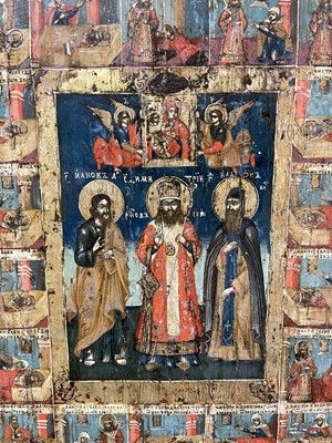 Lot 93 - An icon of three chosen saints with scenes from their lives