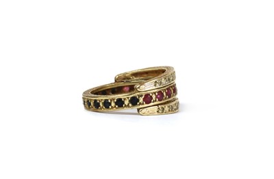 Lot 102 - A 9ct gold ruby and sapphire 'night and day' eternity ring