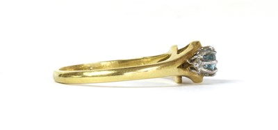 Lot 105 - An 18ct gold three stone aquamarine and diamond ring