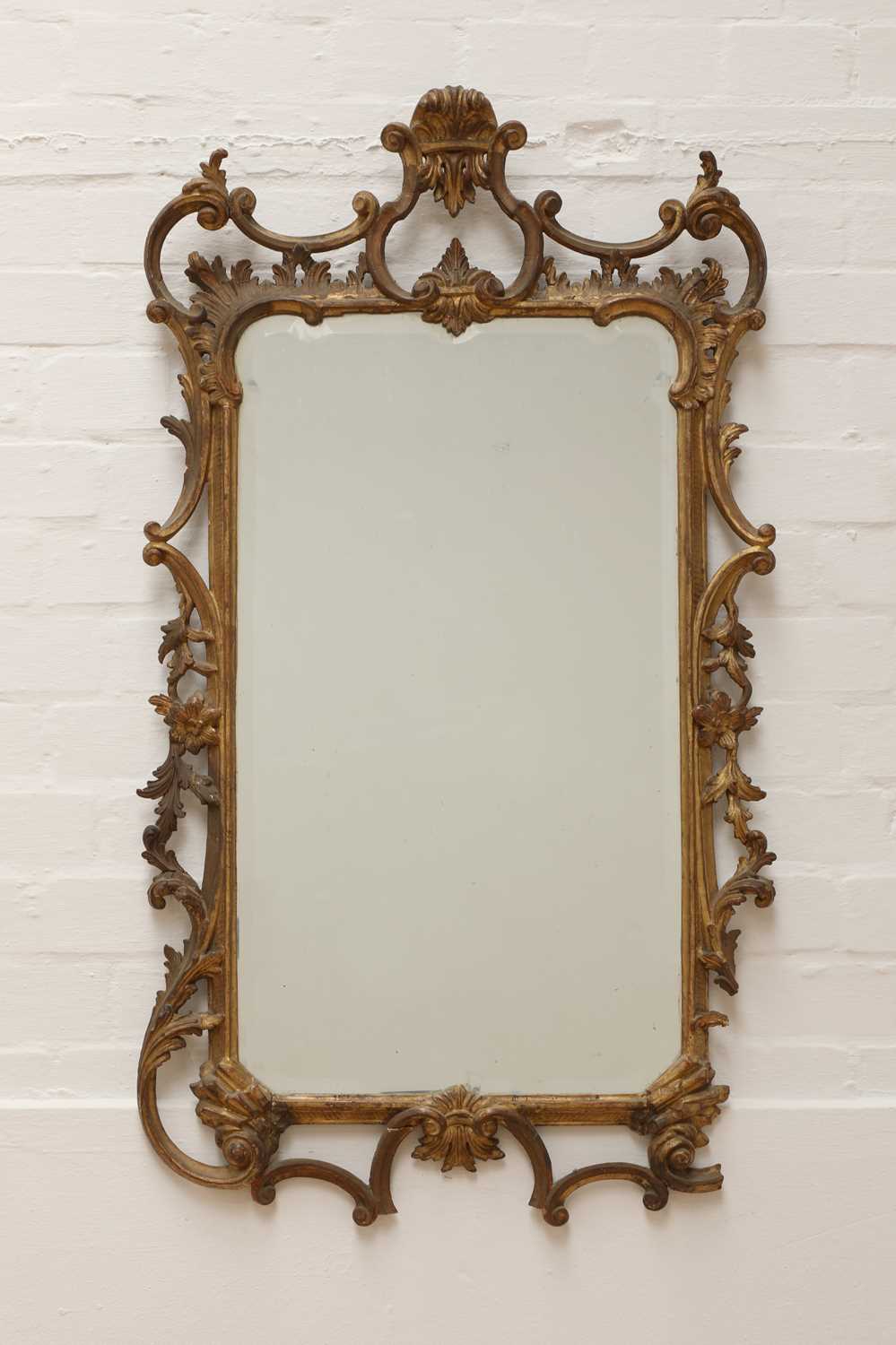 Lot 71 - A George III-style carved giltwood wall mirror