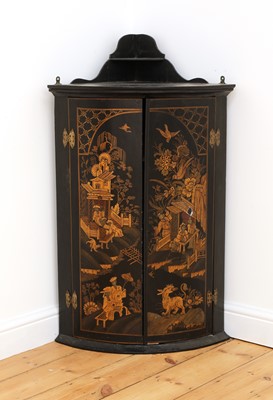 Lot 330 - A black lacquered bow fronted hanging corner cabinet