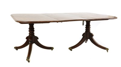 Lot 328 - A Regency mahogany twin pillar dining table
